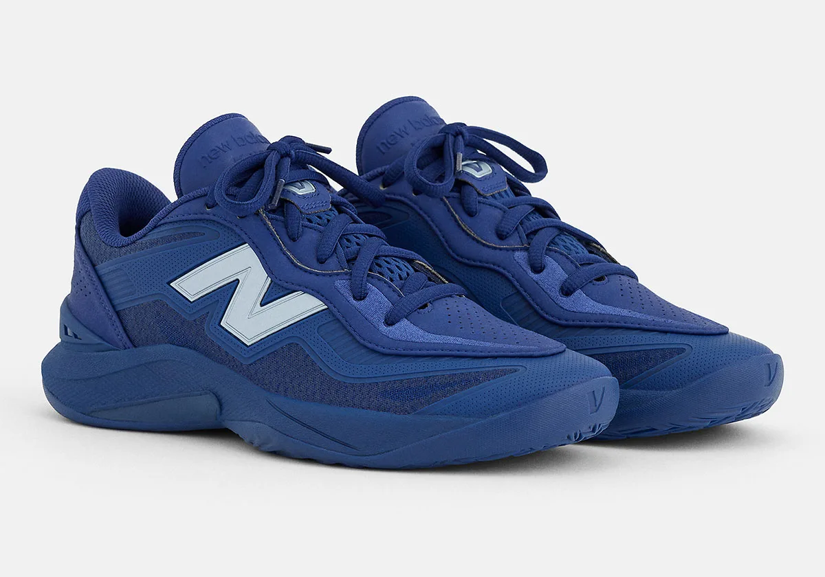 Three-quarter view of blue pair with pale blue N logo, thick laces and chunky blue midsole, Balance Kawhi 5
