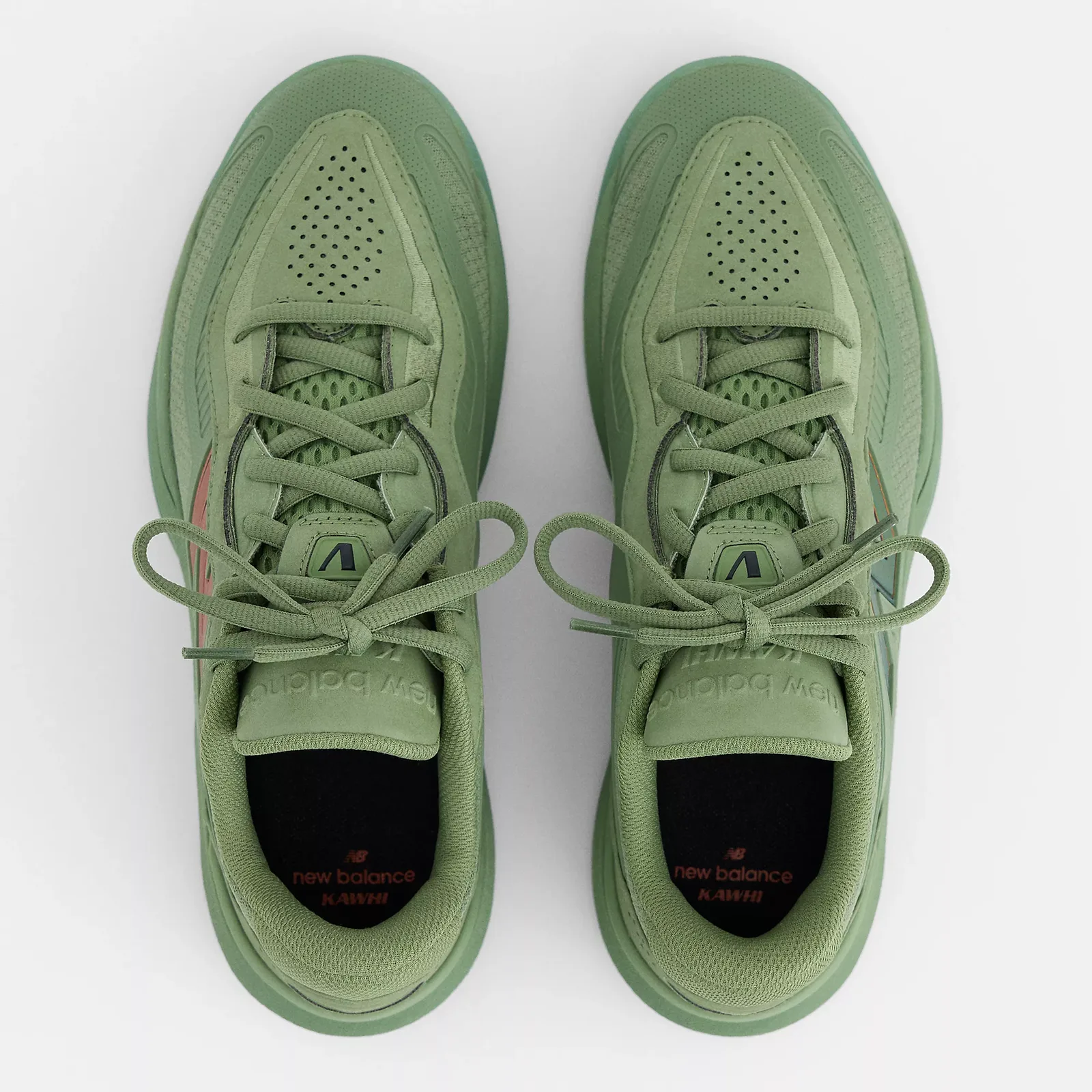 Top-down view of pair, green laces tied in bows, perforated toe boxes, black insoles with KAWHI text, Oregano