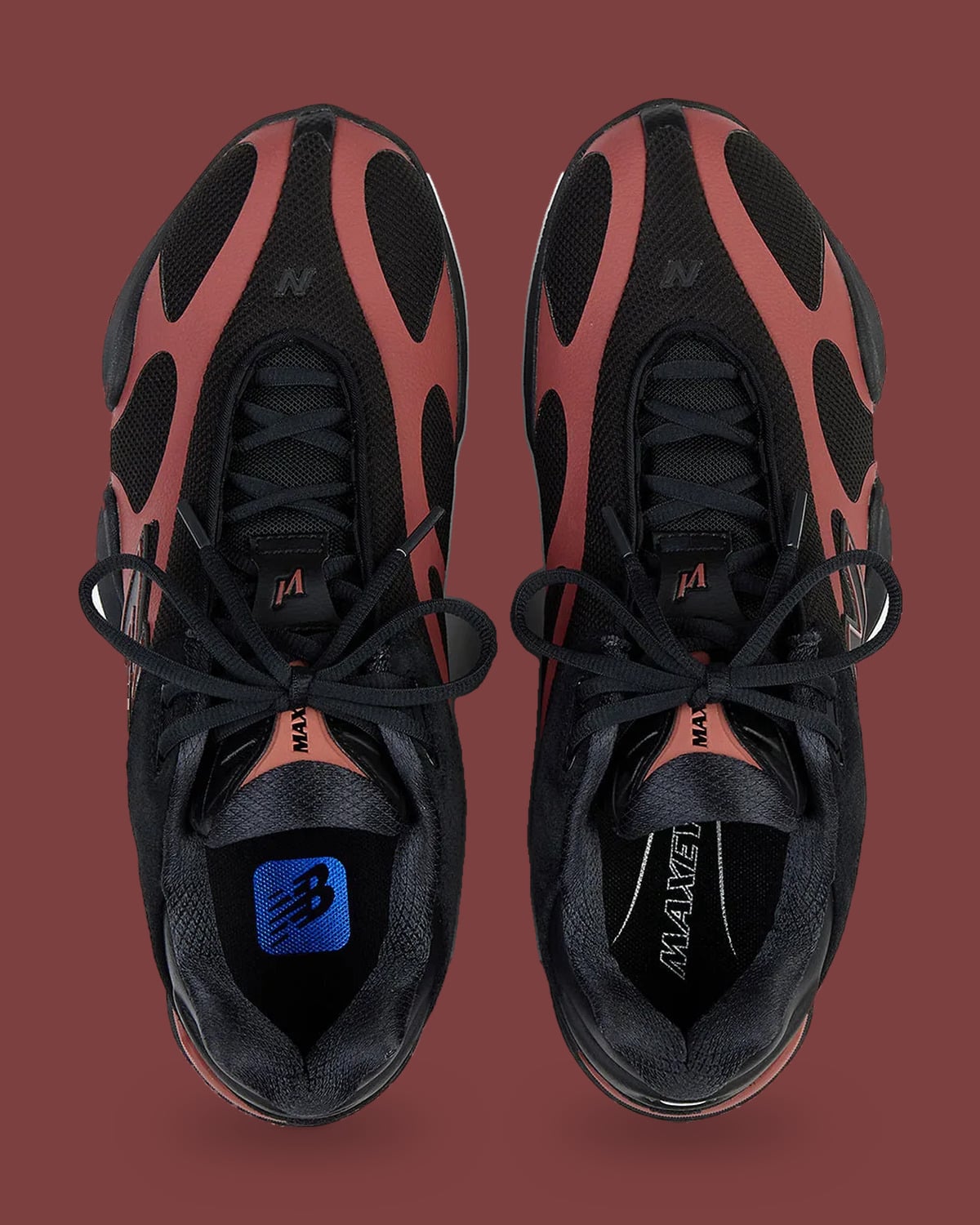 Top-down view of pair, laced black uppers, red-brown overlays, blue logo insole, Red Rock