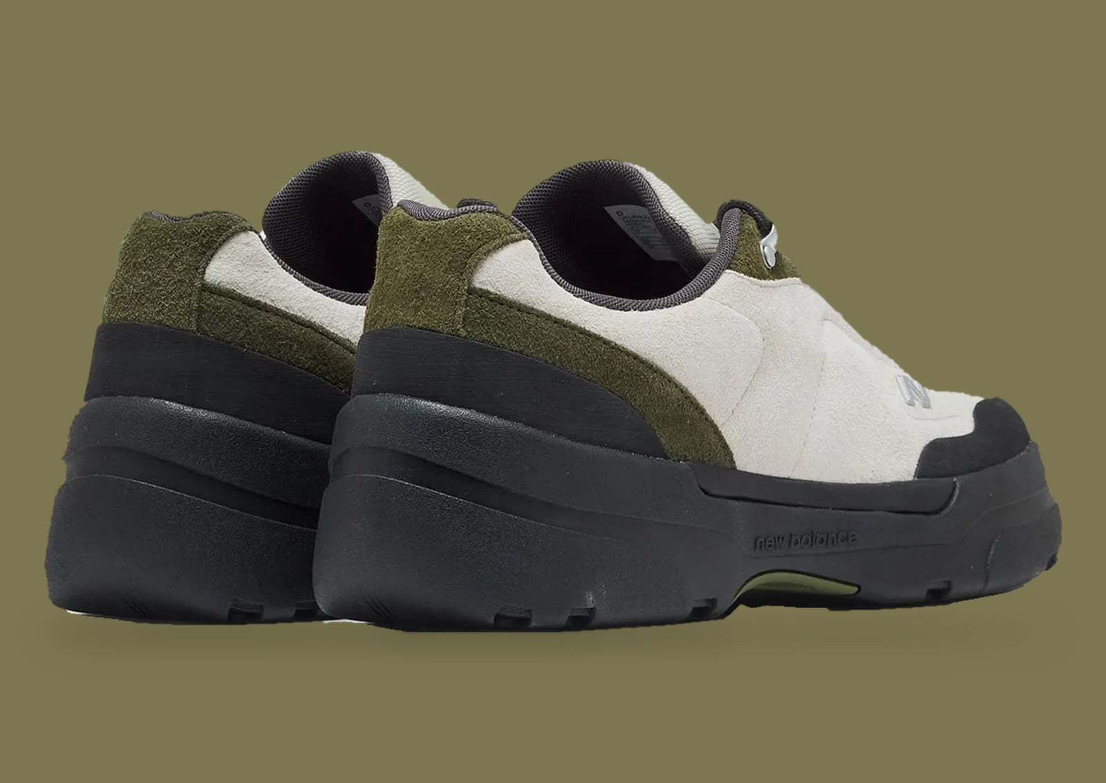 Pair from the rear, cream and olive suede uppers on thick black lug soles, olive backdrop, Army Green