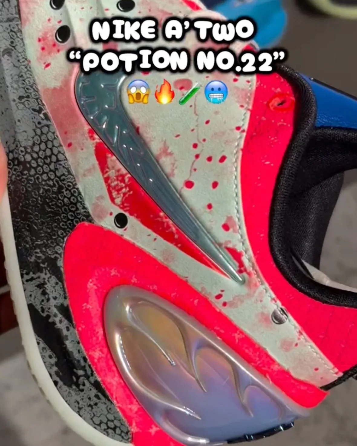 Close-up of heel on mint upper with red splatter, silver-blue swoosh, hot pink heel counter and iridescent pod, Potion No. 22