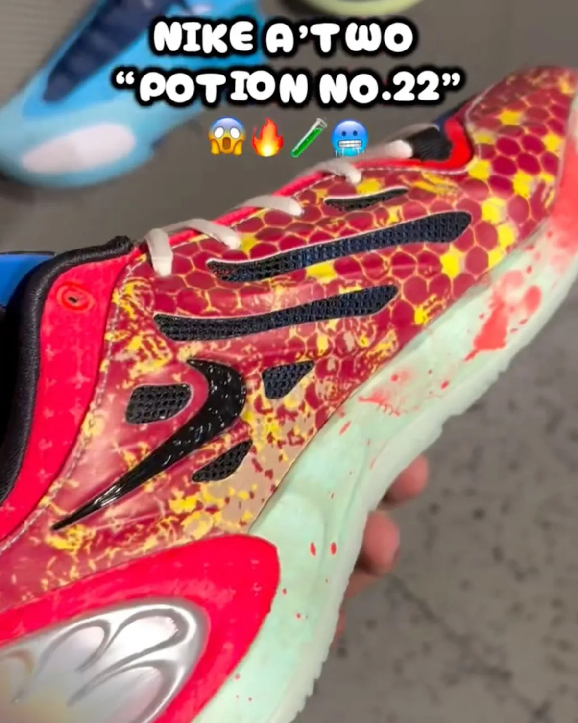 Medial in-hand detail of red upper with yellow honeycomb pattern, black swoosh and mesh slits, mint midsole, Potion No. 22
