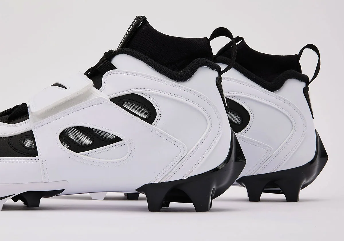 Detail of two heels, white stitched overlays, mesh-lined windows, black collars and black heel studs, White/Black
