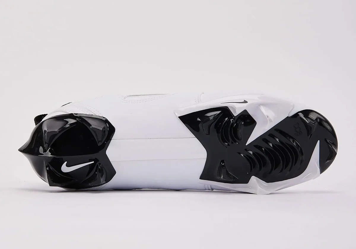 Outsole view, black and white cleat plate with studs, white Swoosh on heel and black Swoosh at forefoot, White/Black