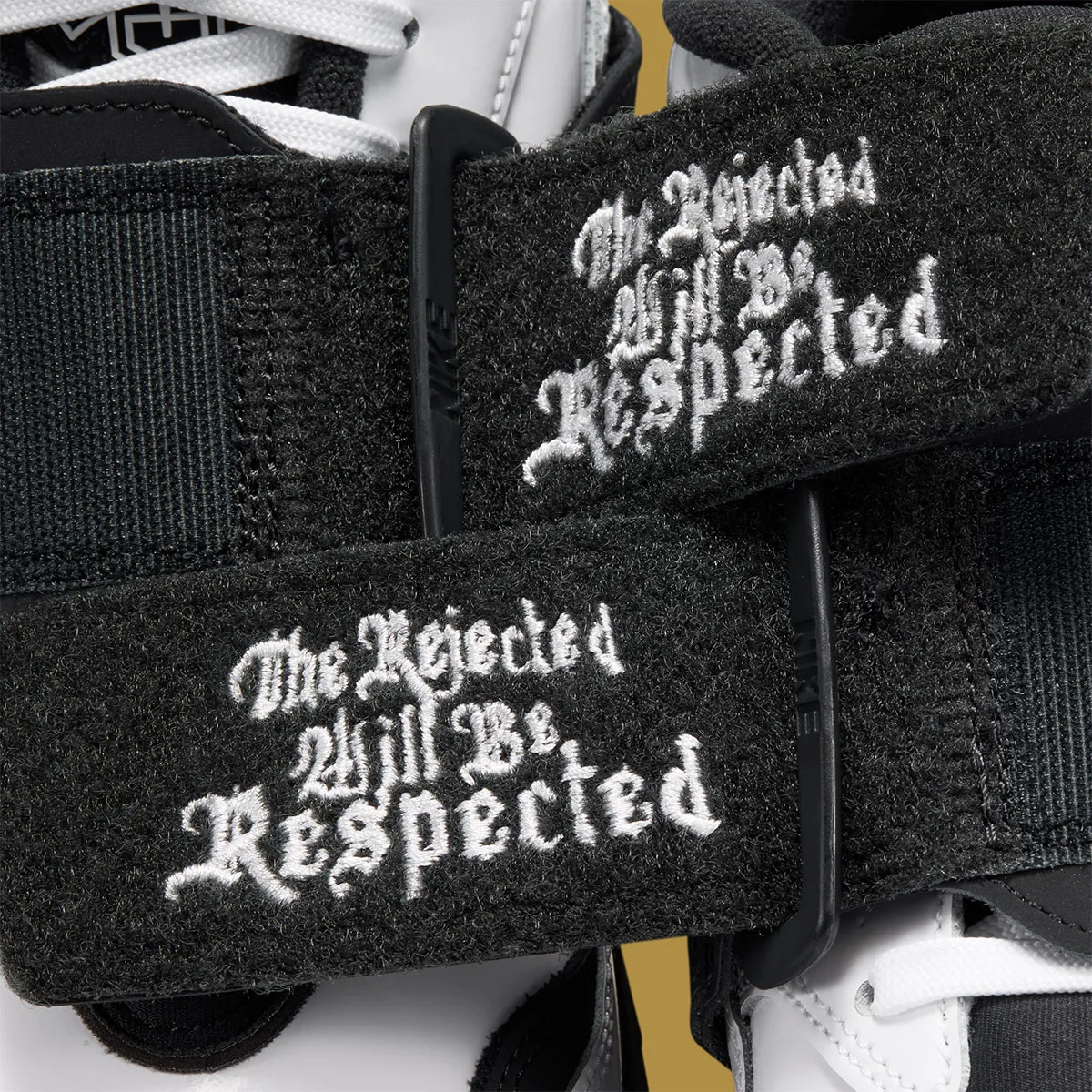 Detail of black strap with white gothic text reading The Rejected Will Be Respected, White/Black
