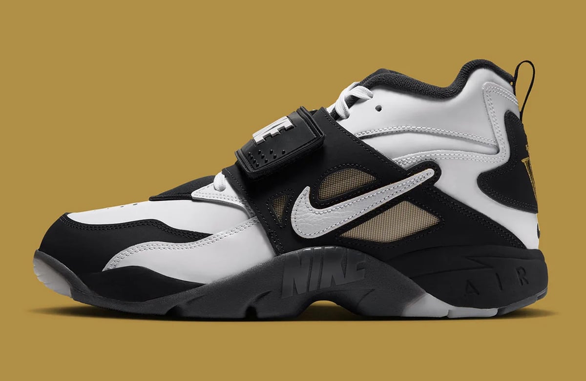 Lateral view, black strap, white swoosh and tan mesh panels on mustard background, White/Black