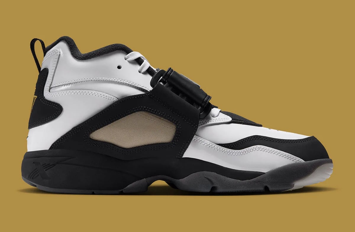 Medial view, black and white upper with tan mesh panel, strap buckle and heel pull loop, White/Black