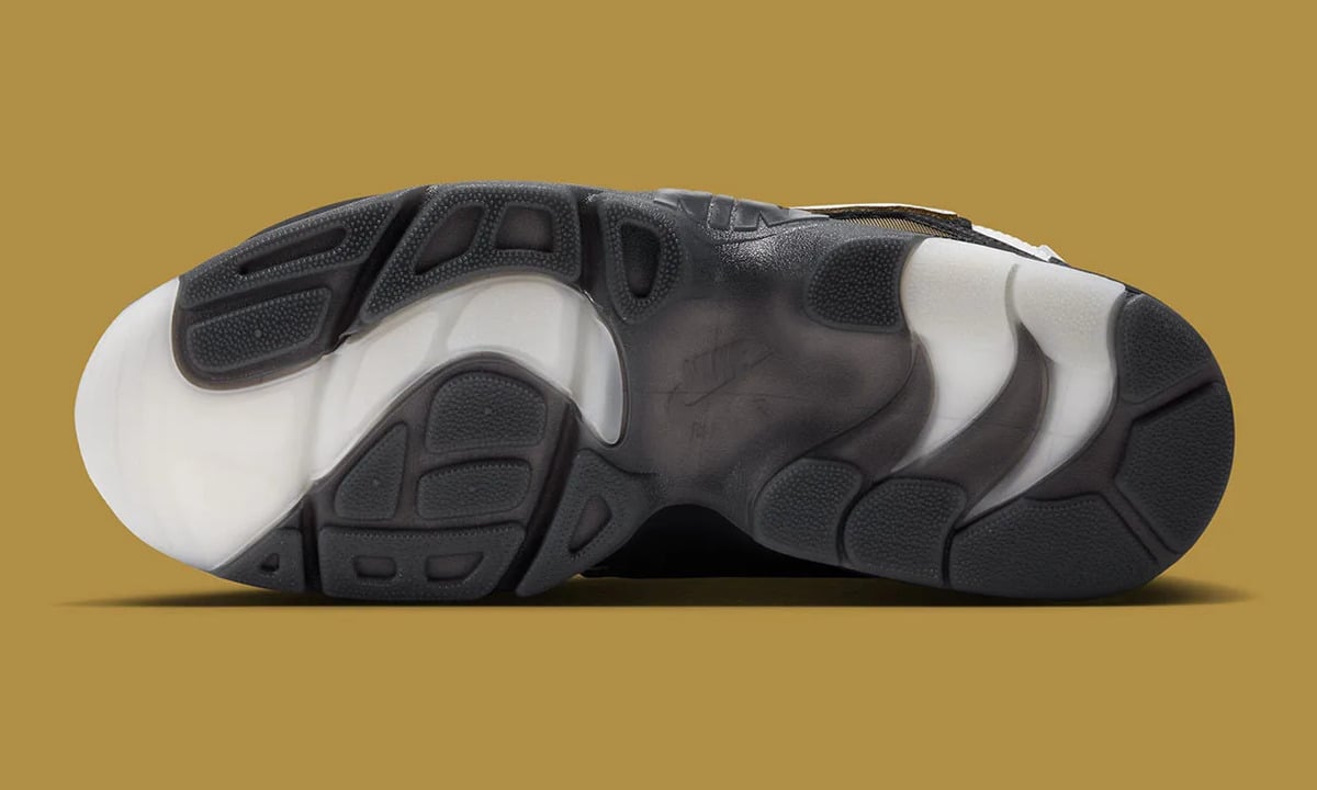 Outsole view, black rubber pods and translucent white sections on mustard background, White/Black