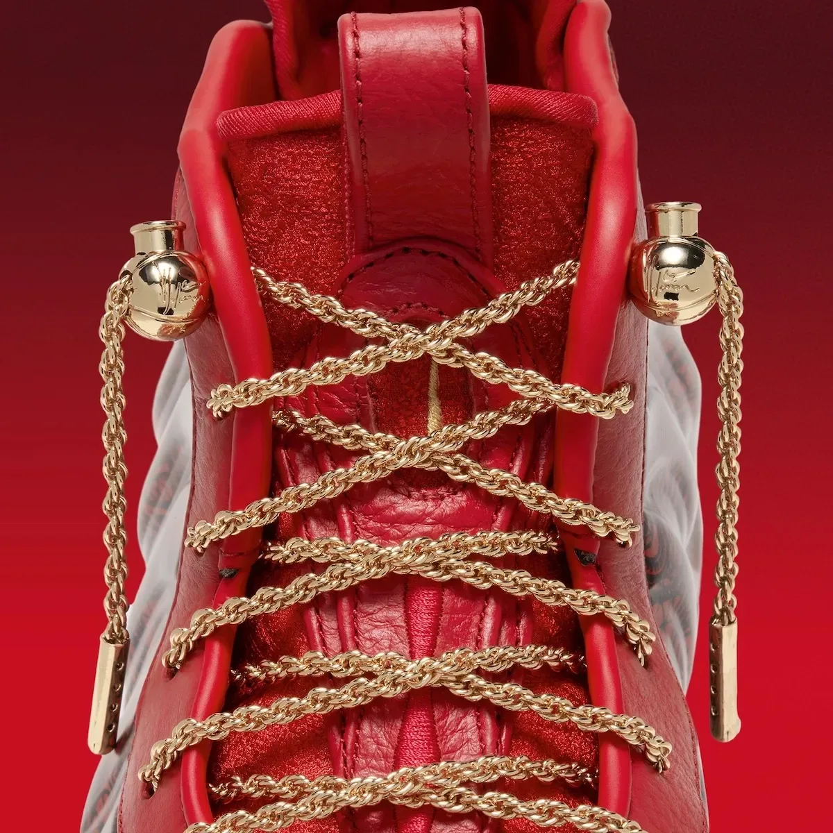 Detail of top of laces, gold chain laces crossed, gold spherical lace locks with engraved logos, Gym Red