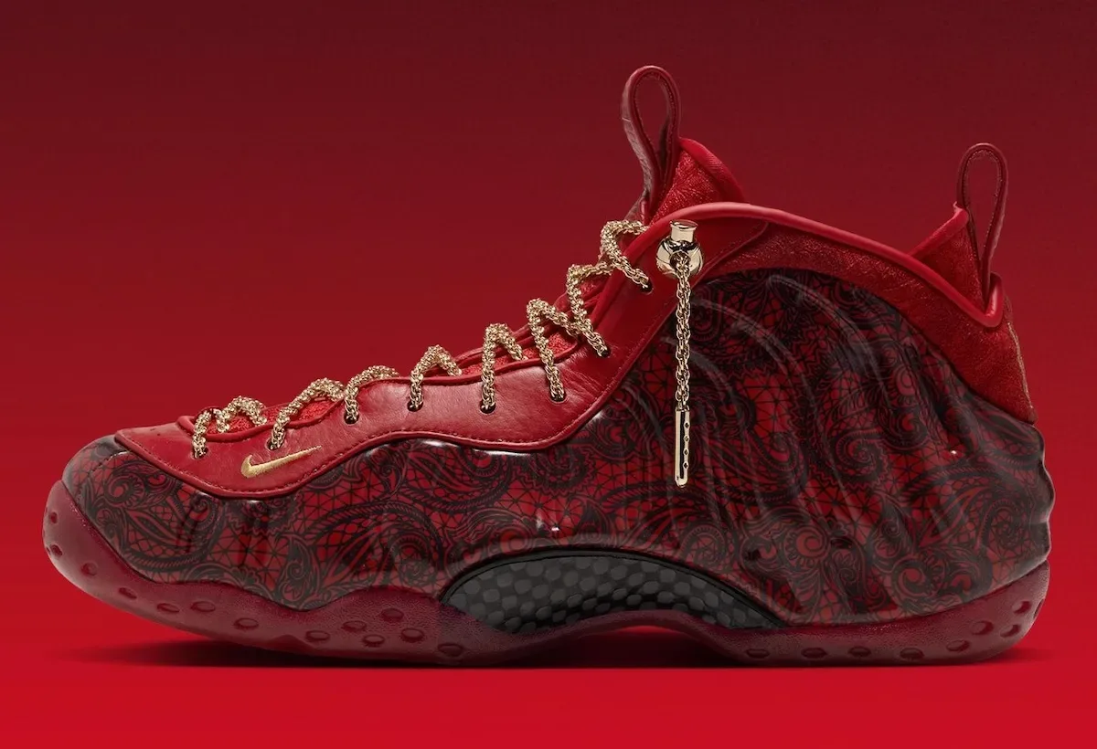 Lateral view on red gradient, black lace-pattern shell, gold chain laces, dangling gold lace charm, Gym Red