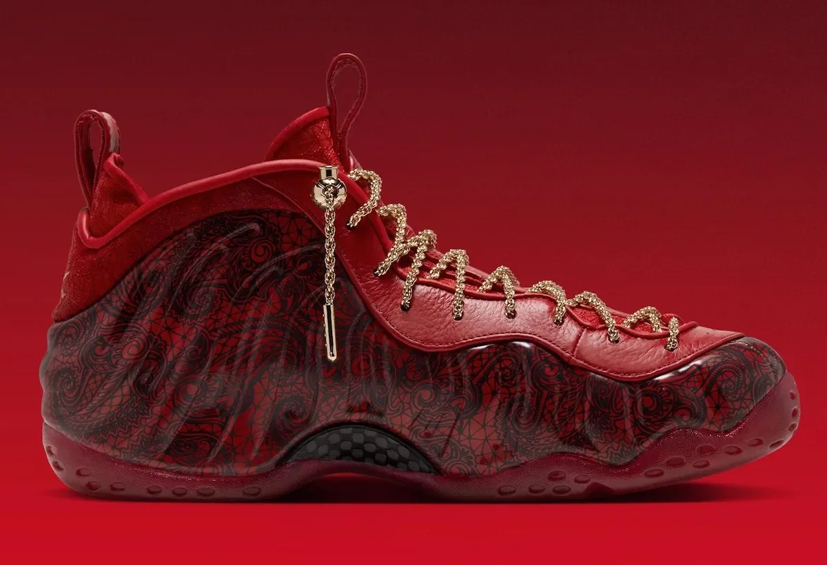 Medial view on red gradient, lace-print upper, gold chain laces, gold lace charm near the ankle, Gym Red