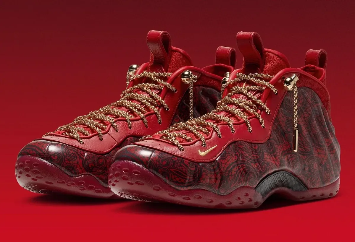Pair, three-quarter front view, gold chain laces and bead locks, red leather and lace-print toe, Gym Red