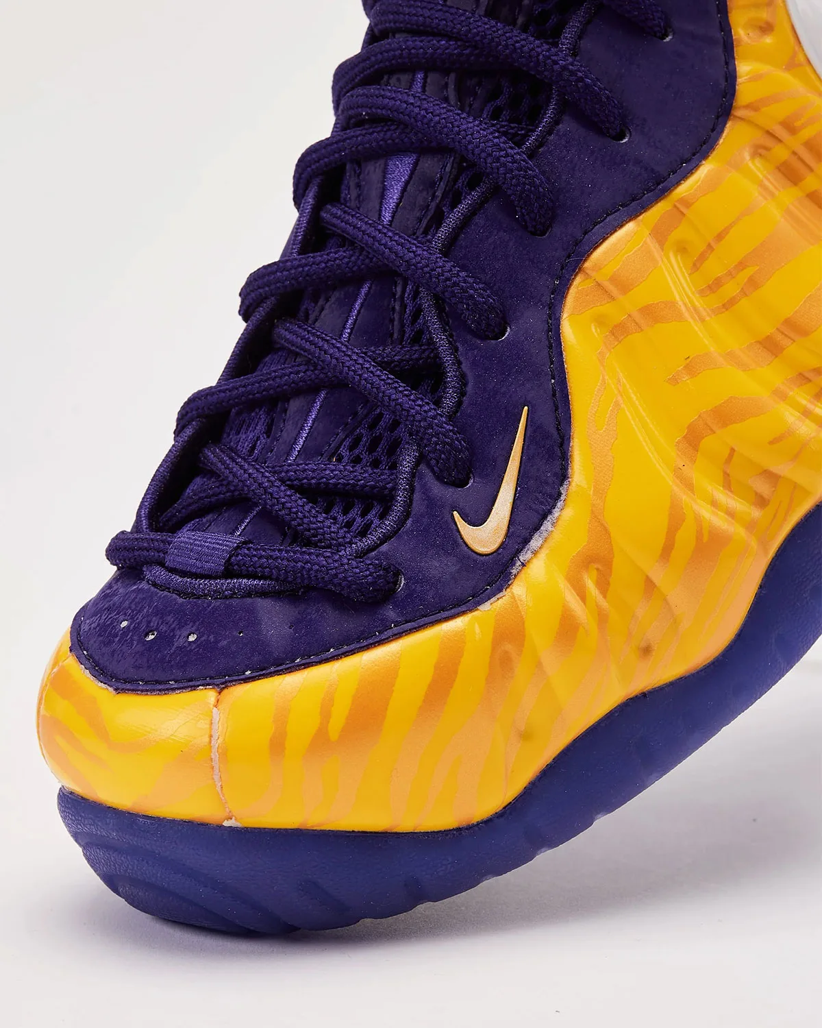 Toe and lace detail, purple laces and suede overlay, small gold swoosh, gold stripes, LSU Tigers