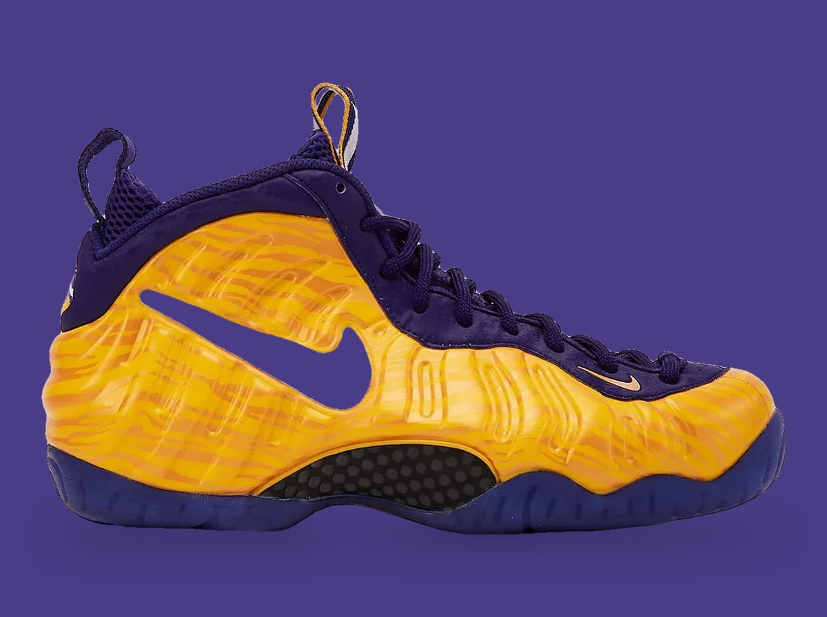 Lateral view, gold tiger-stripe shell, purple cutout swoosh and purple laces on purple background, LSU Tigers