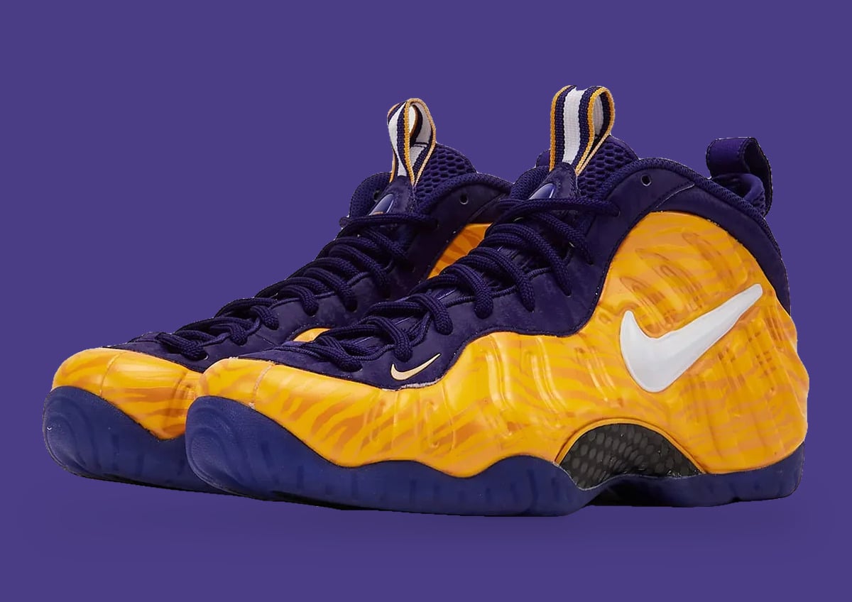 Pair at three-quarter angle, gold tiger-stripe shells, white swoosh and purple laces, LSU Tigers
