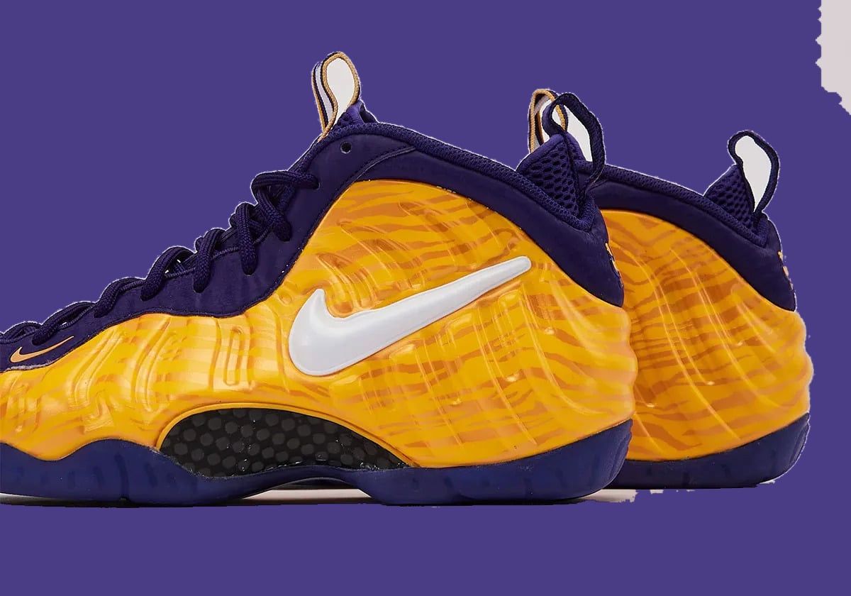Lateral detail of pair, large white swoosh on gold tiger-stripe shell, purple heel tabs, LSU Tigers