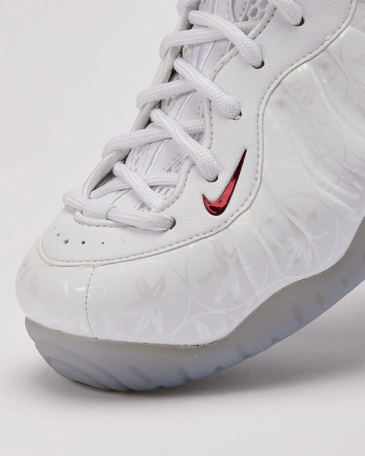 Toe detail, white laces, small red swoosh, embossed leaf pattern, icy translucent sole, Ohio State