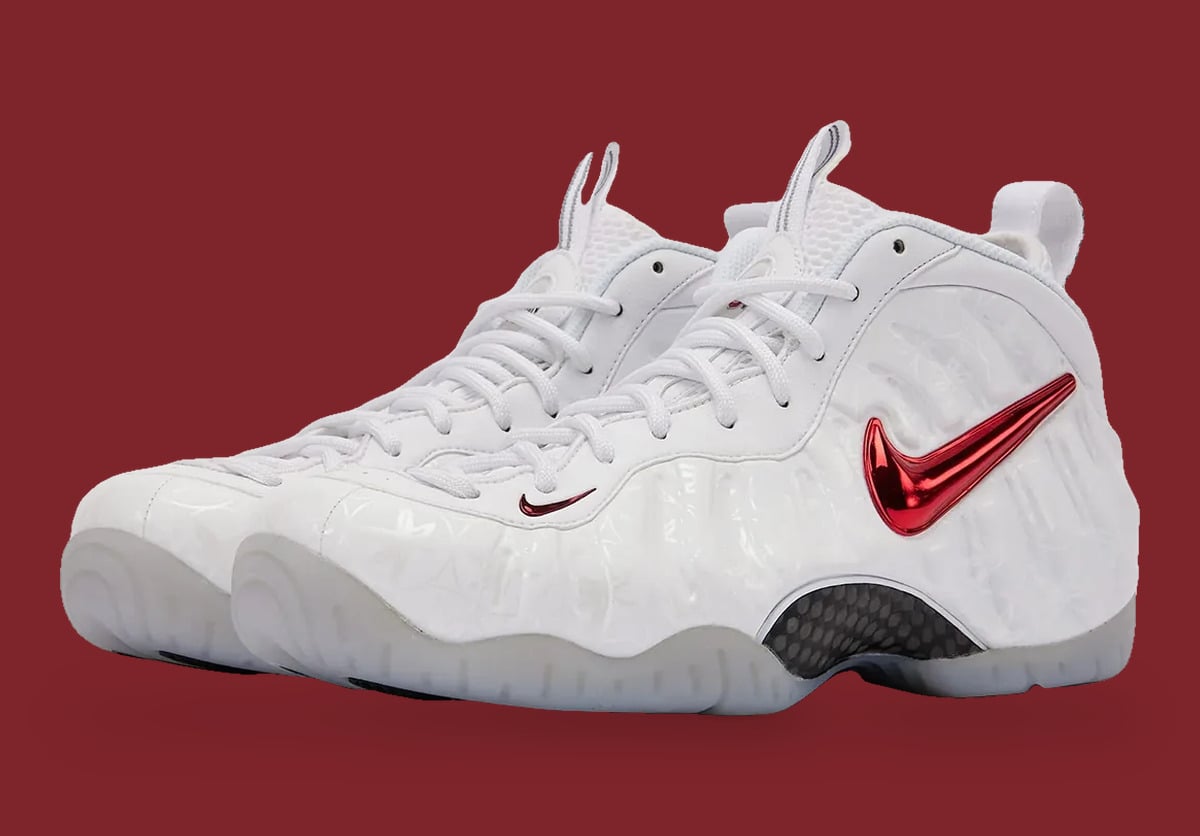 Pair, lateral three-quarter view, white textured upper, red chrome swoosh, maroon backdrop, Ohio State