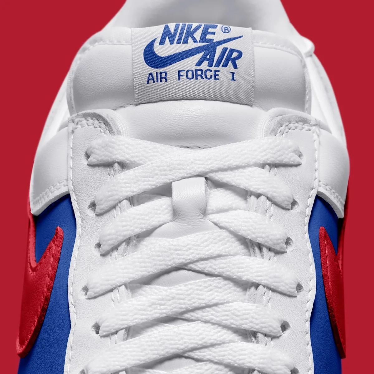 Detail of white laces and Nike Air Force I tongue label, blue and red panels, Philly