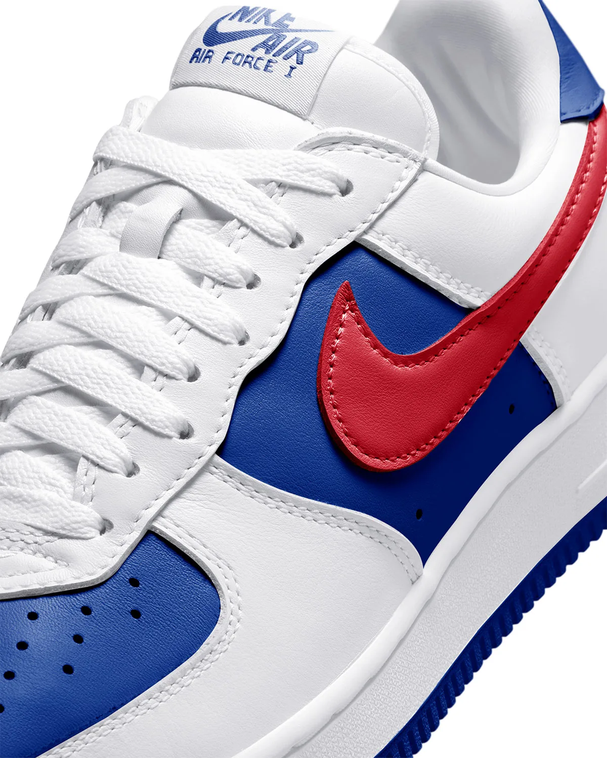 Detail of lace area, red stitched swoosh on blue panel, white leather, tongue label, Philly