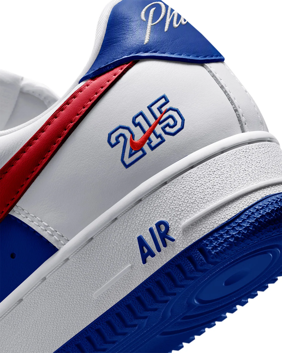 Detail of heel, outlined 215 numerals with red check, blue Phila tab, blue AIR on midsole, Philly