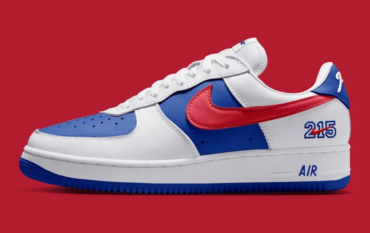 Lateral view, red swoosh, blue panels, 215 numerals and blue AIR on white midsole, Philly