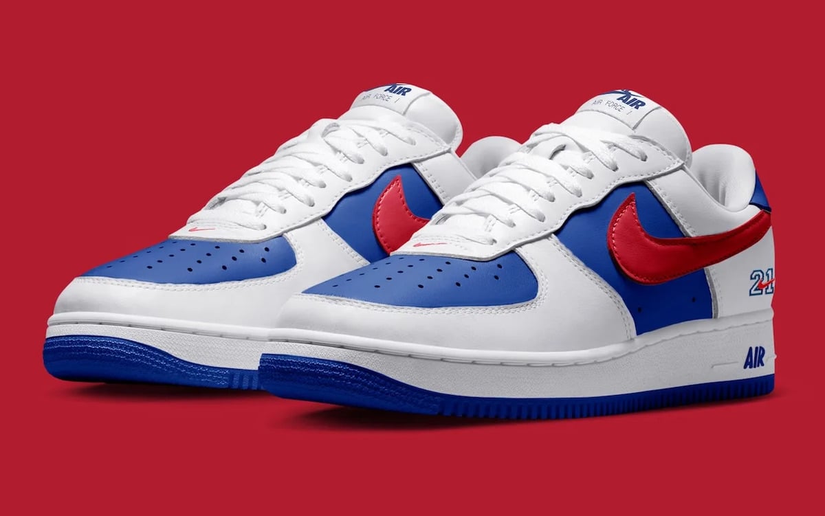Pair, three-quarter view, blue toe boxes, red swooshes, 21 and AIR on heel side, red backdrop, Philly