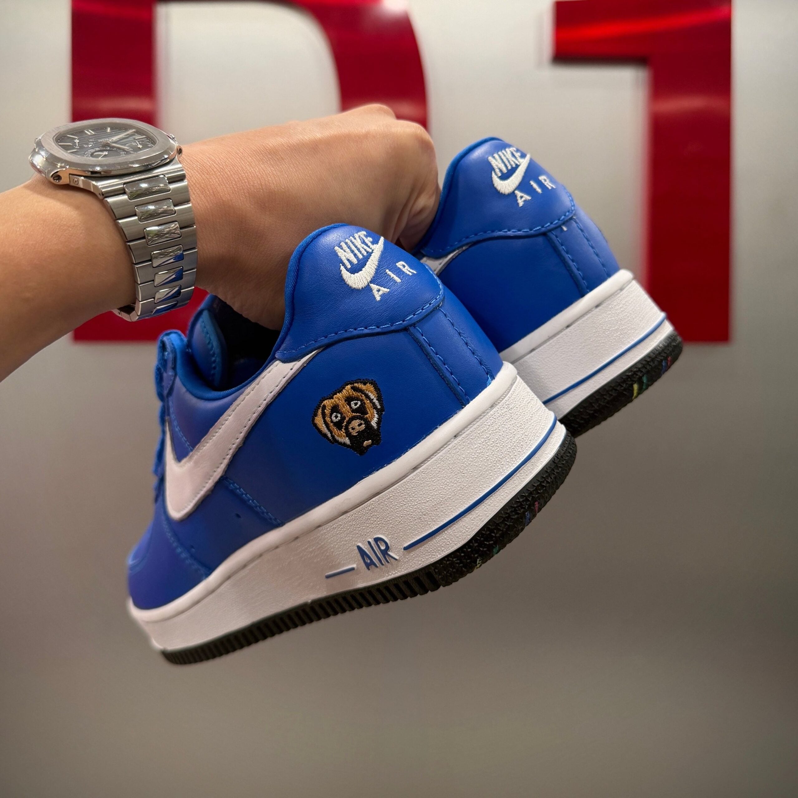 in-hand heel view, blue pair with embroidered bulldog patch and white midsole, Blue