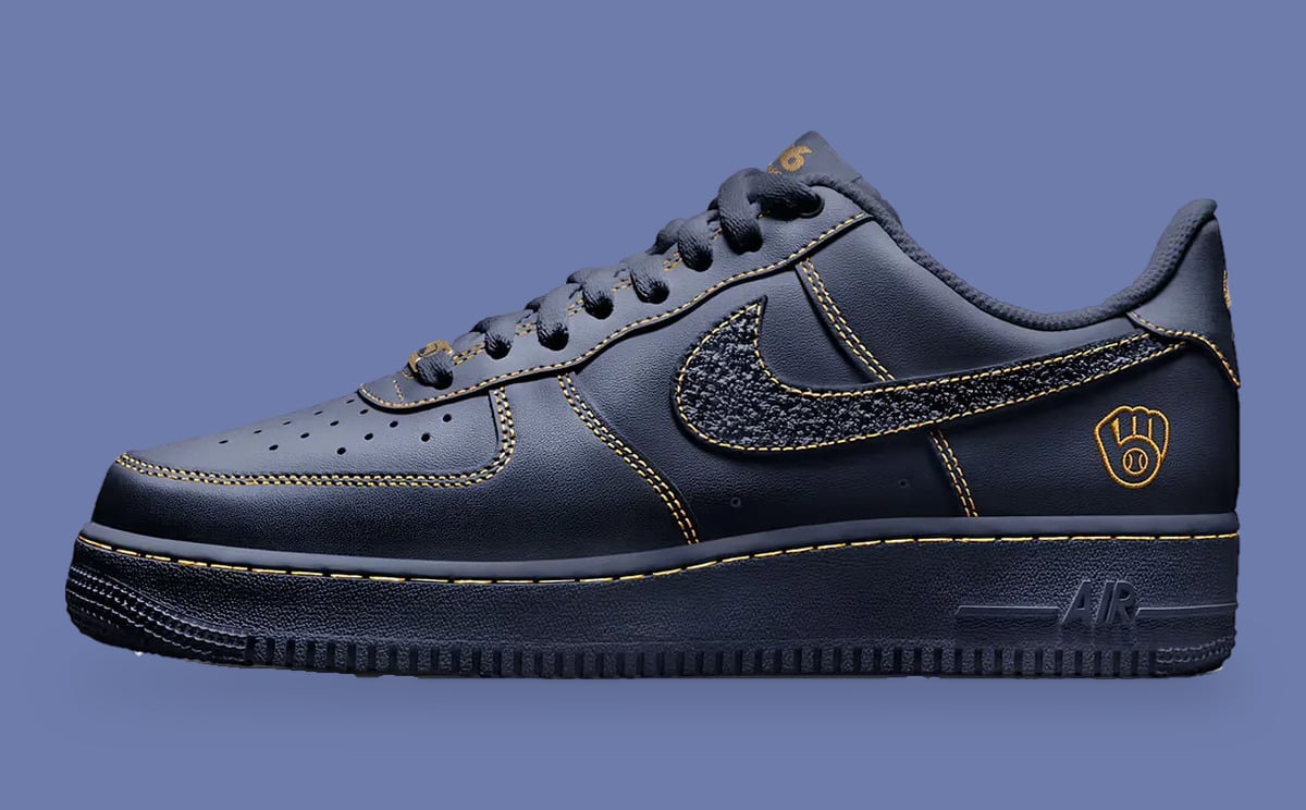 Lateral view, navy leather with gold stitching, textured swoosh and gold glove logo on heel, Milwaukee Brewers