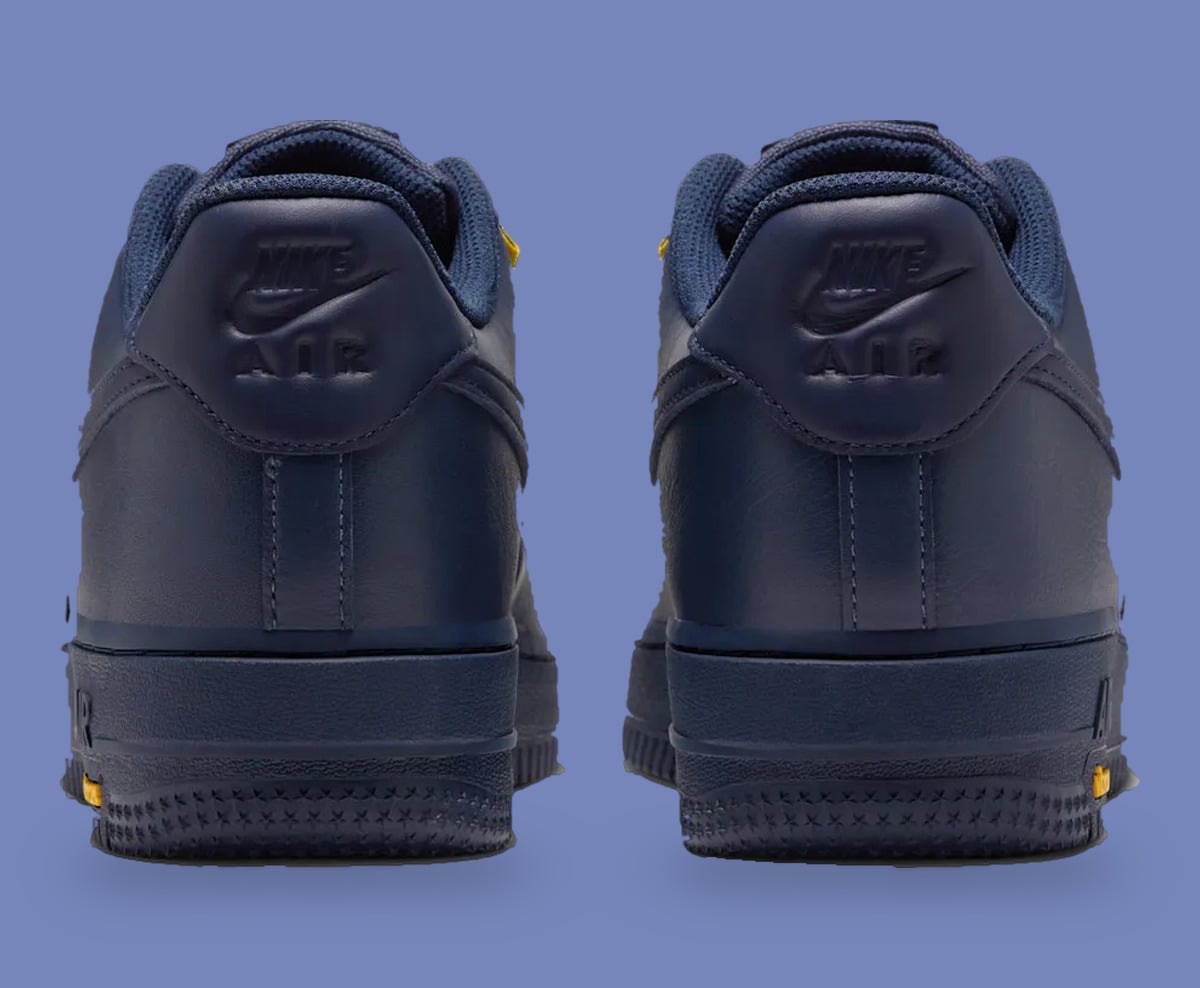 Heel view of pair, navy embossed Nike Air heel tabs on periwinkle background, Thunder Blue