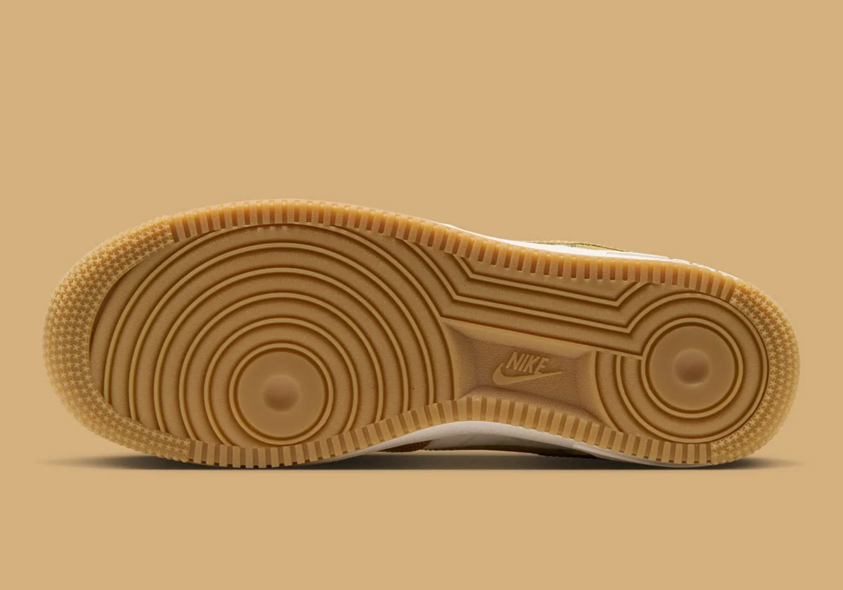 Outsole view on tan background, gum rubber circular tread pattern with Nike logo, Lace