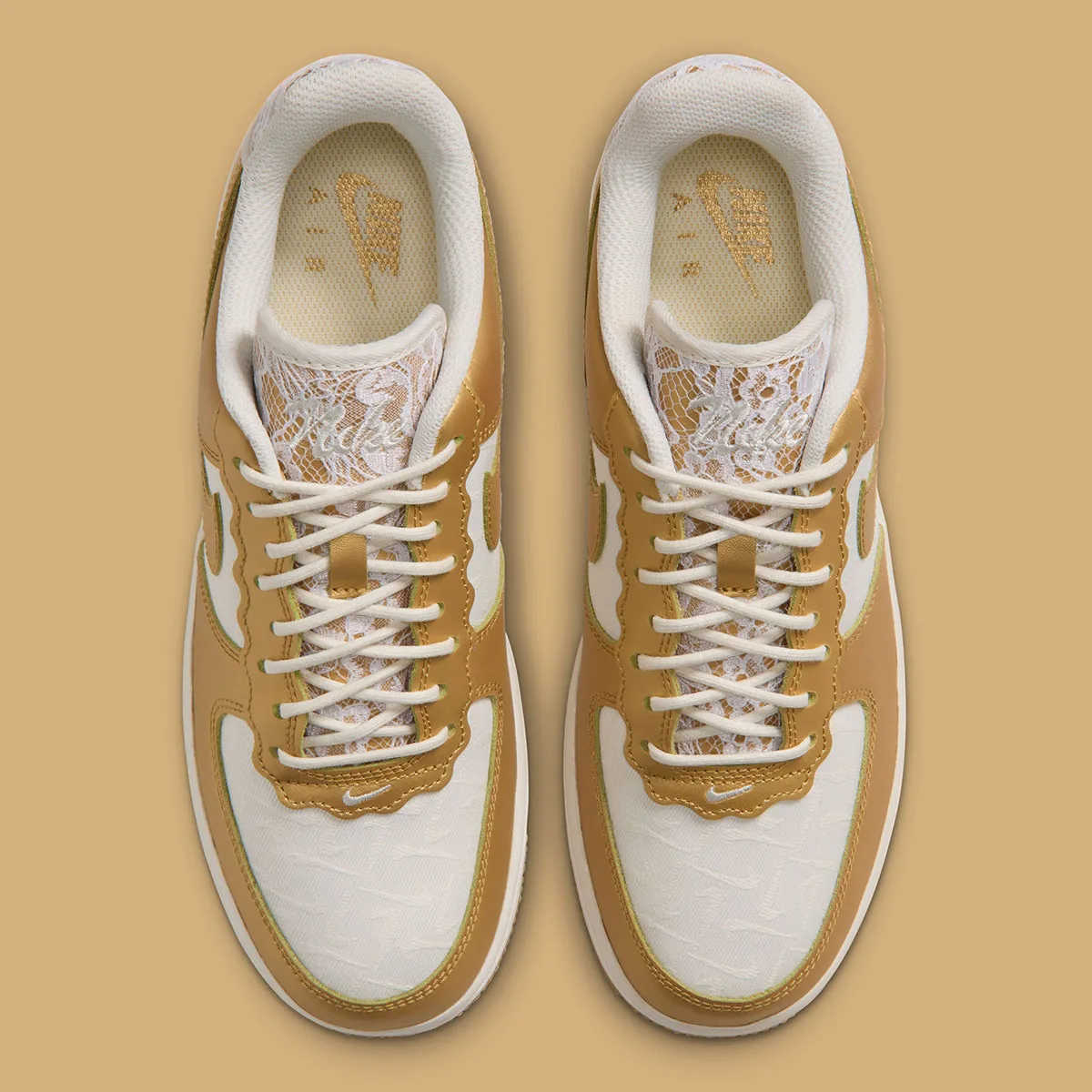 Top-down view of pair, cream laces over lace tongues, gold insoles with Nike text, Lace