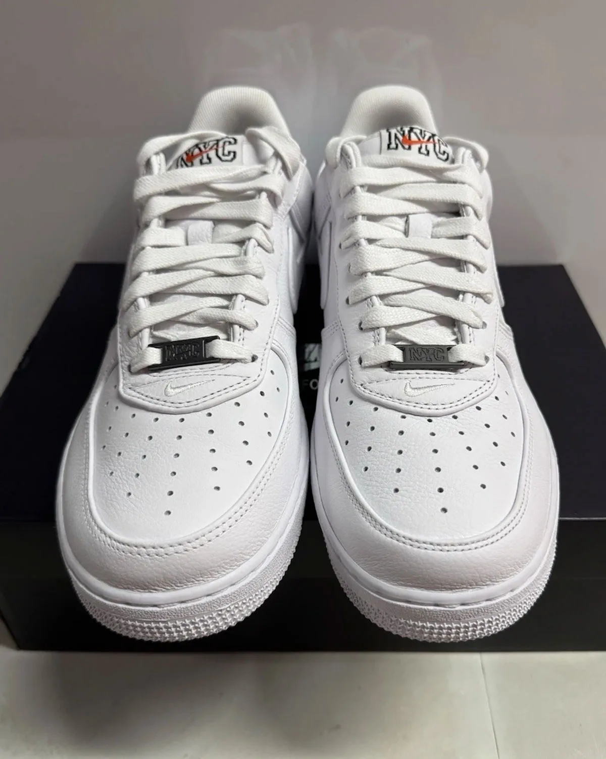 Front three-quarter view of the pair of NYC Triple White