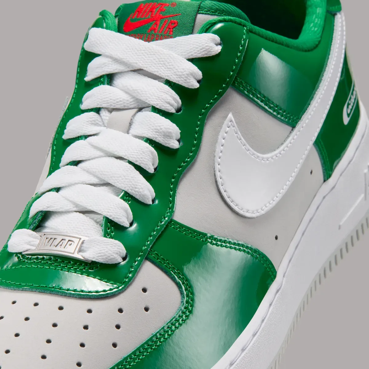 Lace and side detail with a silver VLAP tag and white Swoosh, Pine Green