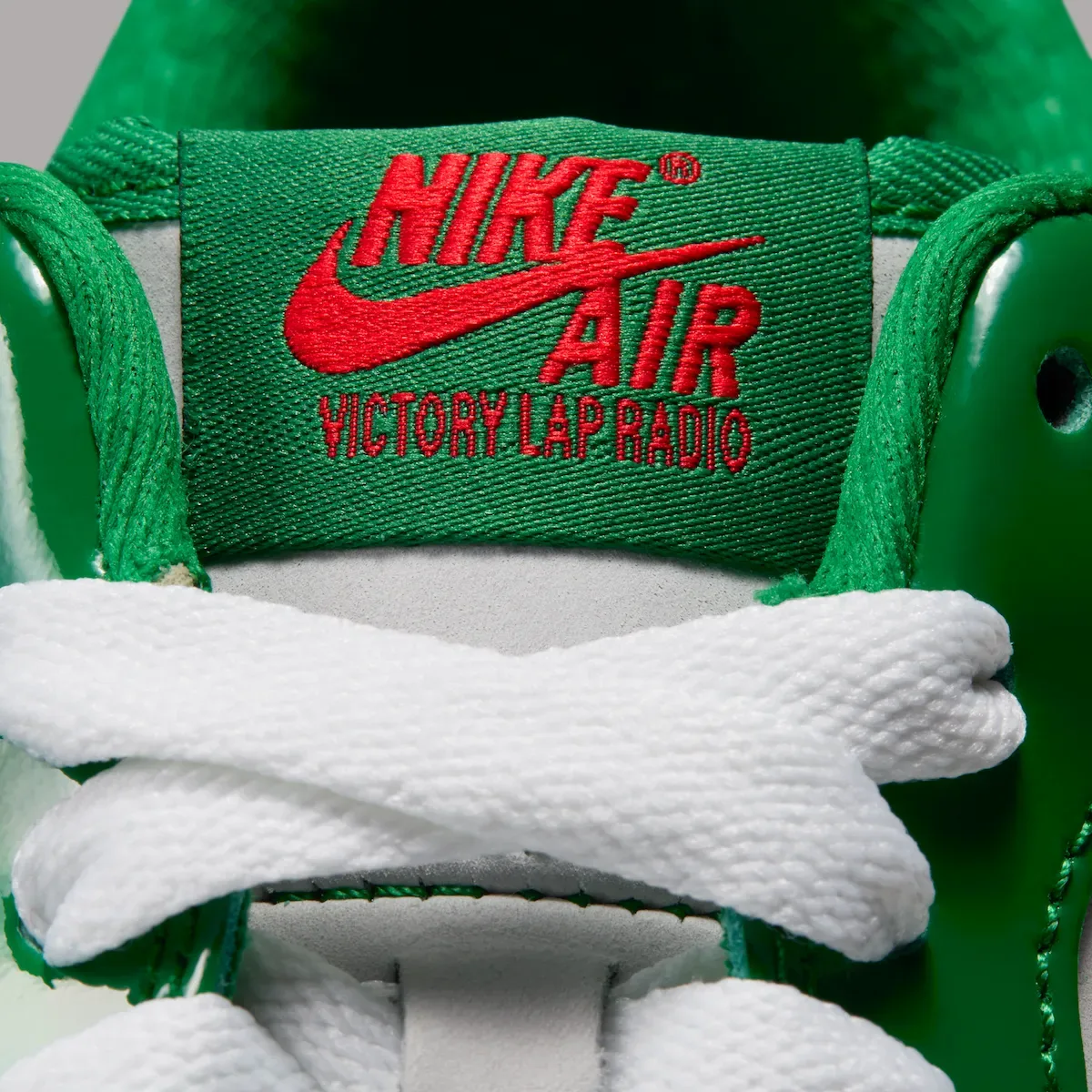 Tongue label detail with red Nike Air and Victory Lap Radio text on green, Pine Green