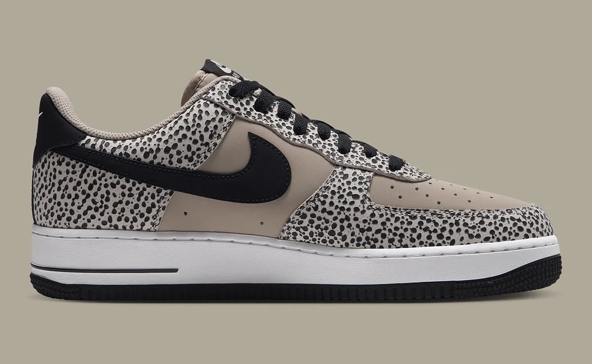 Medial view, black swoosh on taupe leather with dotted panels, white midsole, Safari
