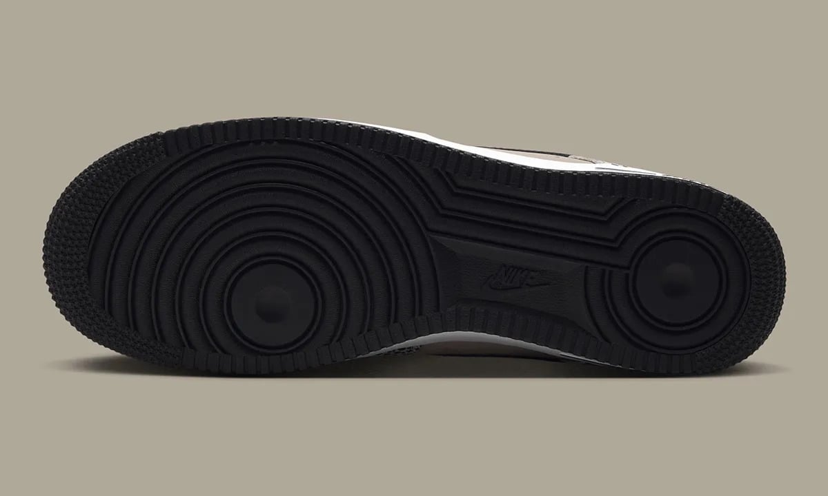 Outsole view, black rubber with circular tread pattern and small Nike logo, Safari