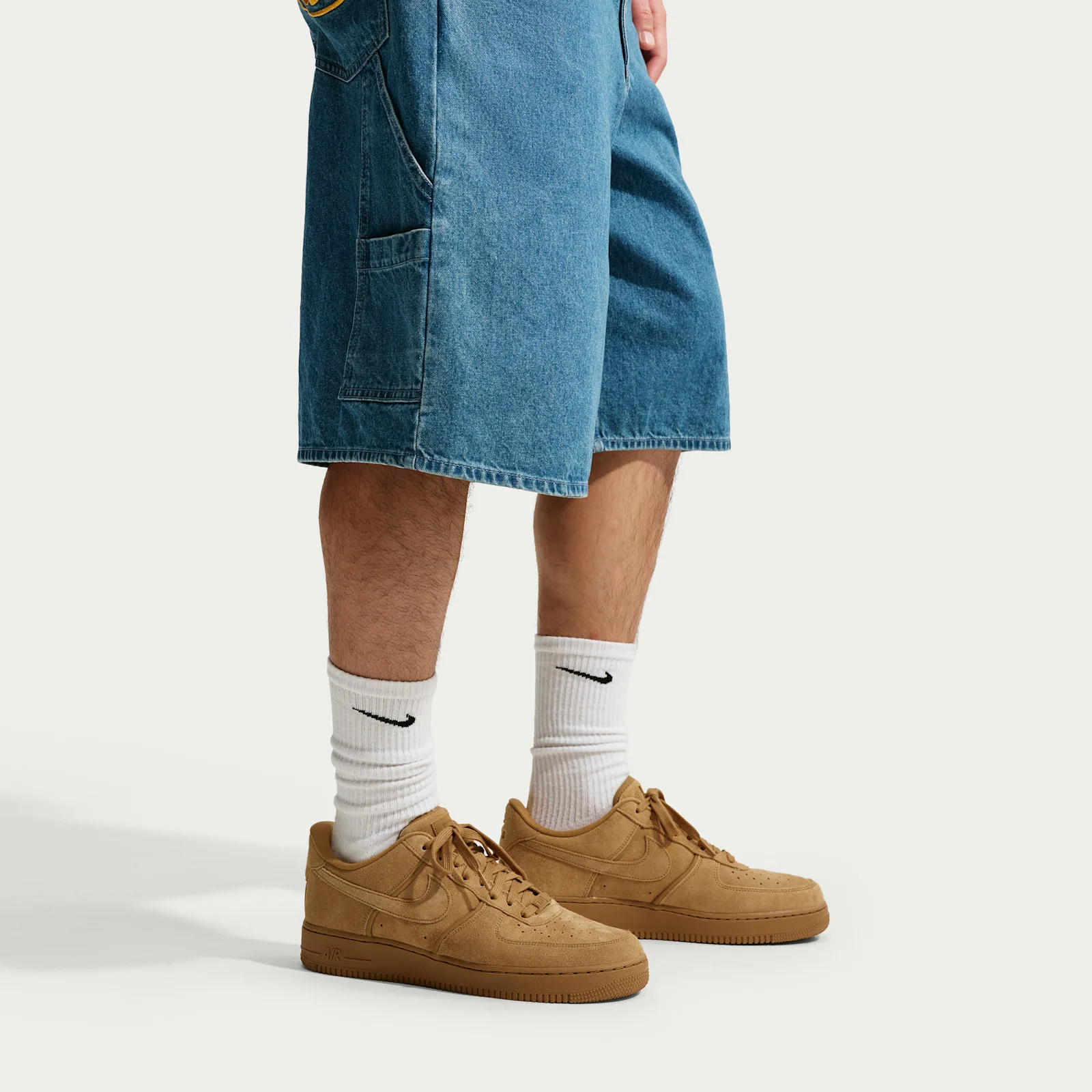 On-foot view with white Nike crew socks and light blue denim shorts, tan suede sneakers on feet, Wheat