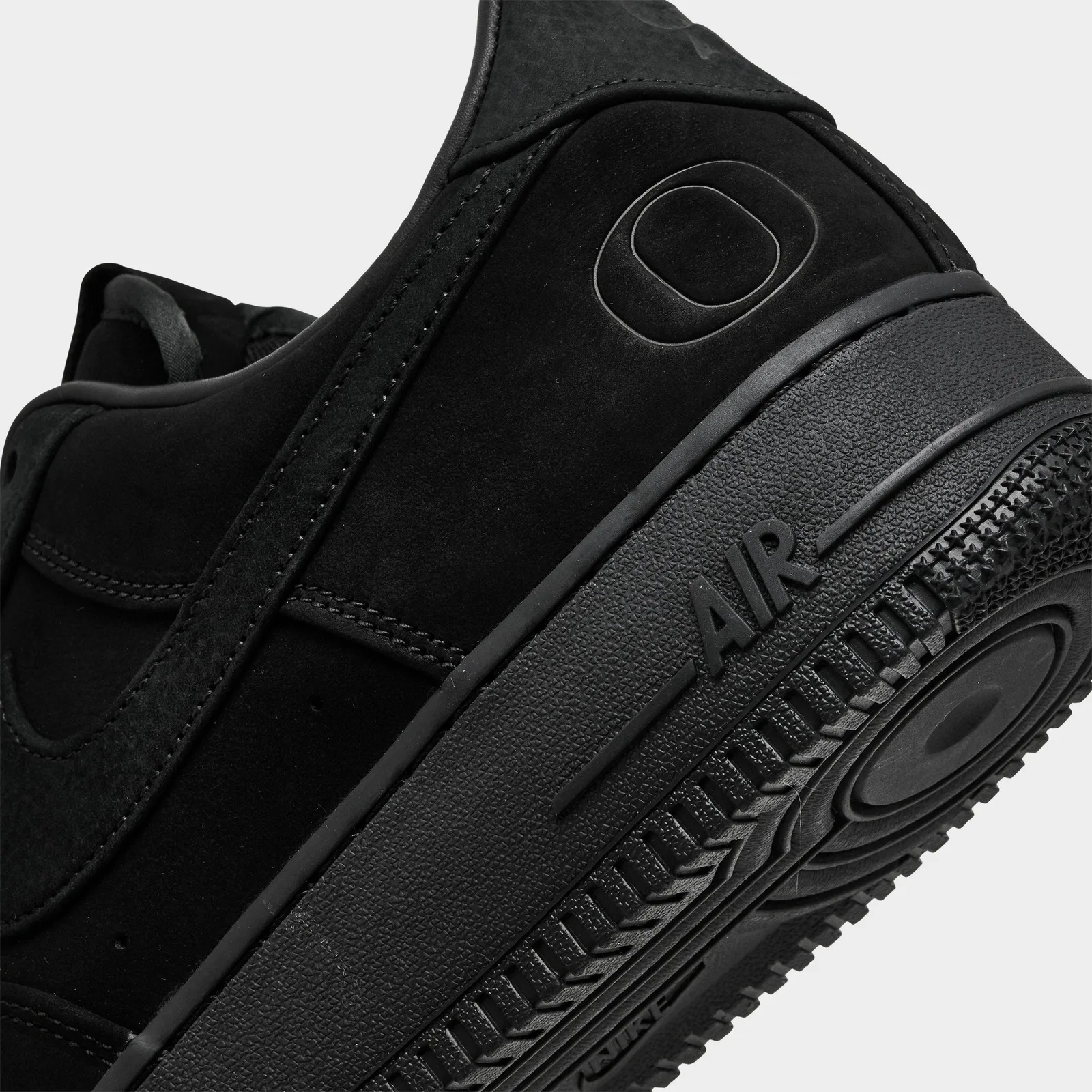 Heel detail with a tonal Oregon O, black suede and raised AIR on the sole, Triple Black