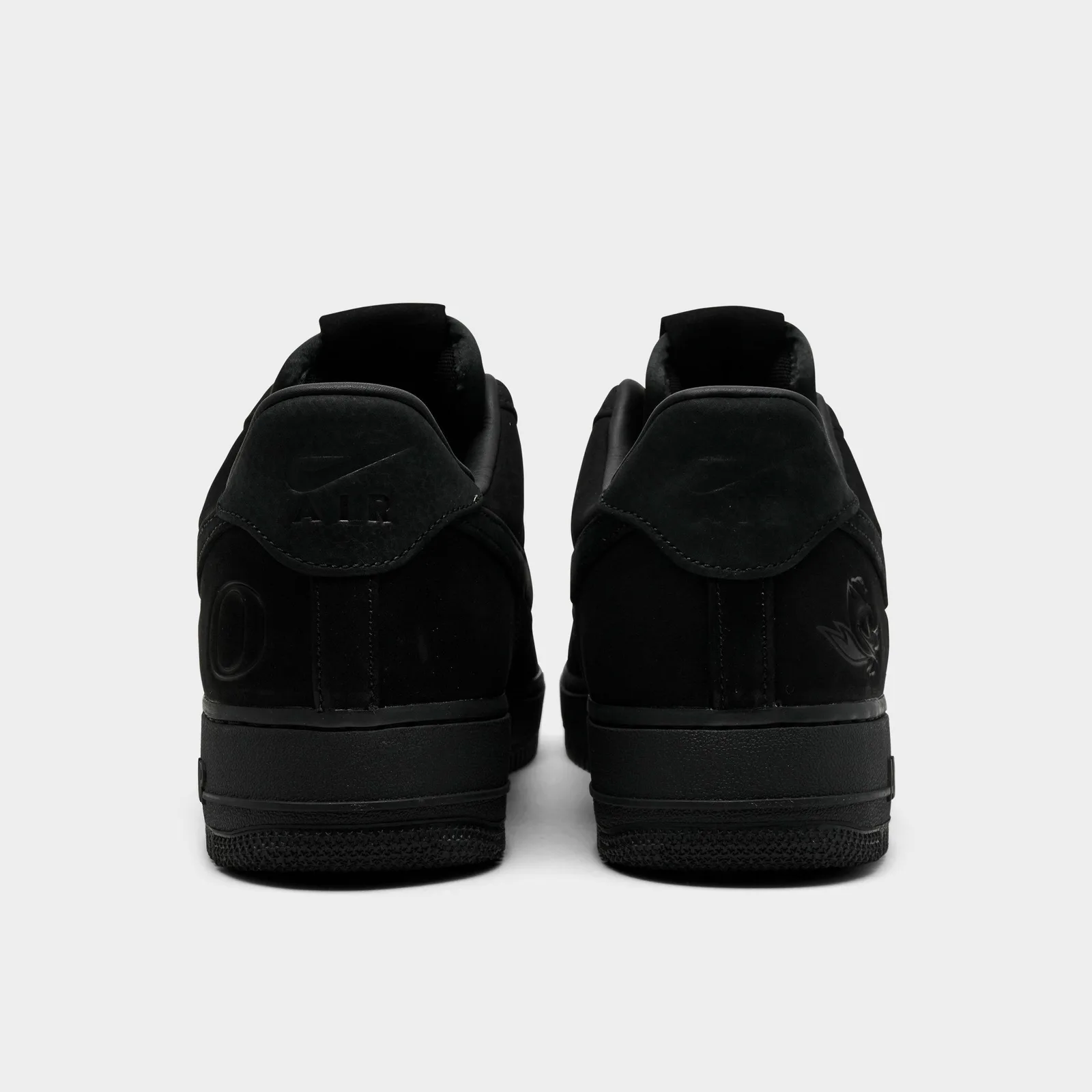 Heel view of black pair with tonal Nike Air, Oregon O and duck logos, Triple Black