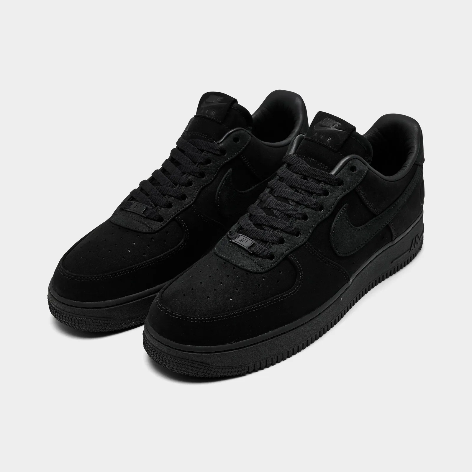 Angled pair with black suede uppers, perforated toes and AF1 lace tags, Triple Black