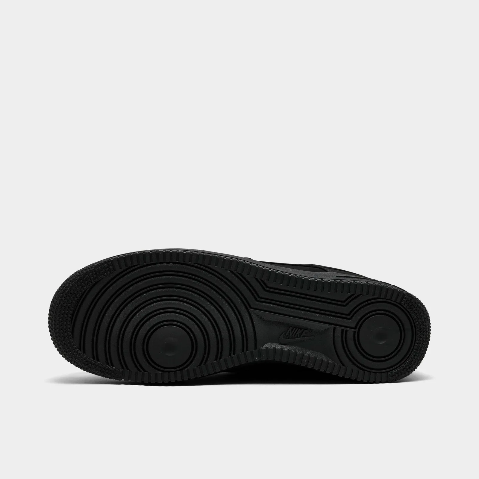 Black outsole with circular traction grooves and a central Nike logo, Triple Black