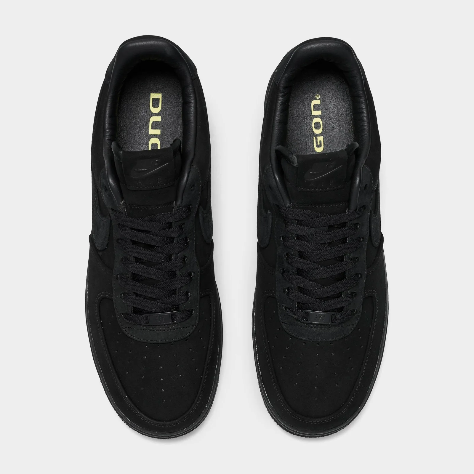 Top-down pair with black laces and pale yellow lettering on the insoles, Triple Black
