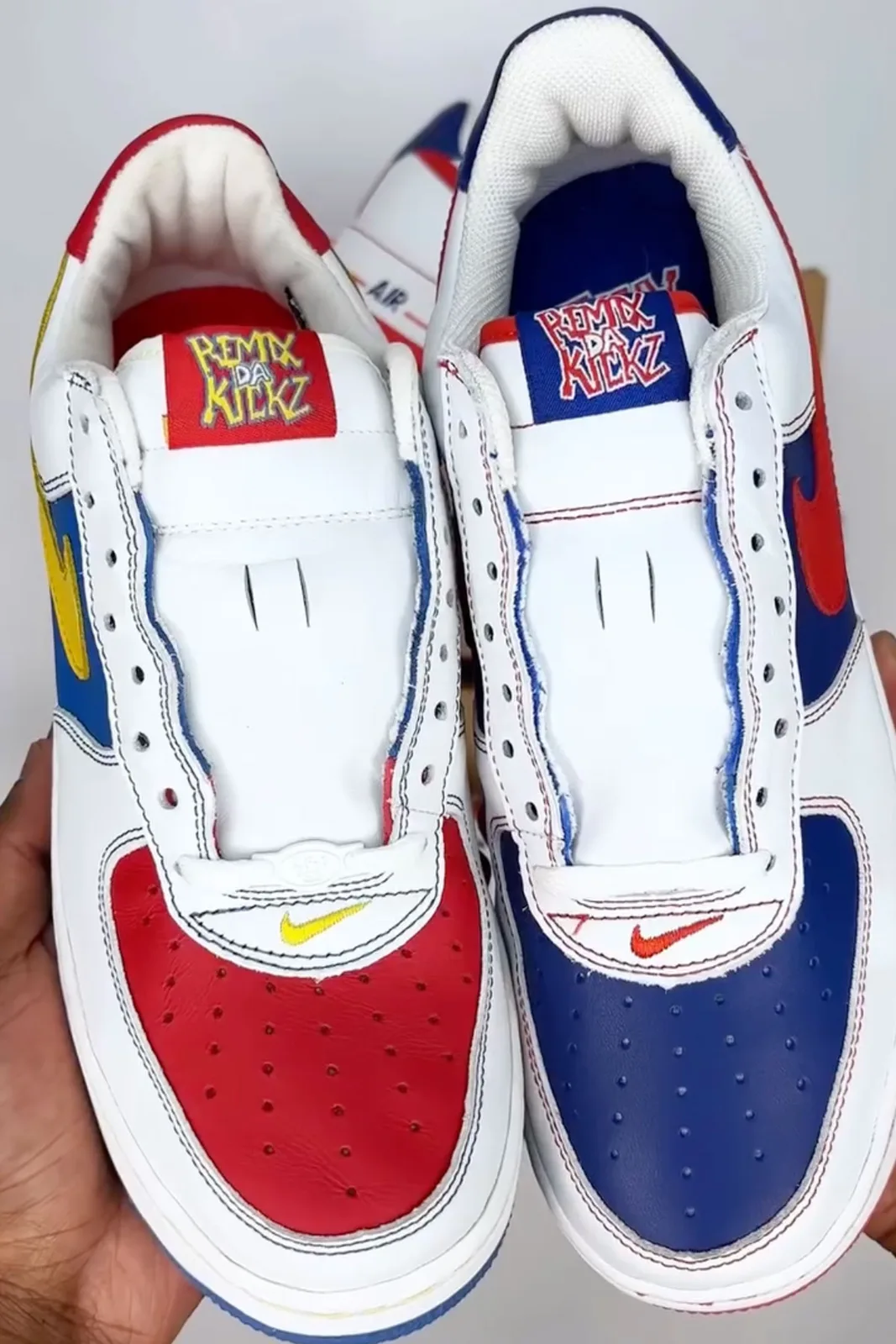 two toe-to-tongue views in hand, remix da kickz tongue tags in red and blue, Remix Da Kickz