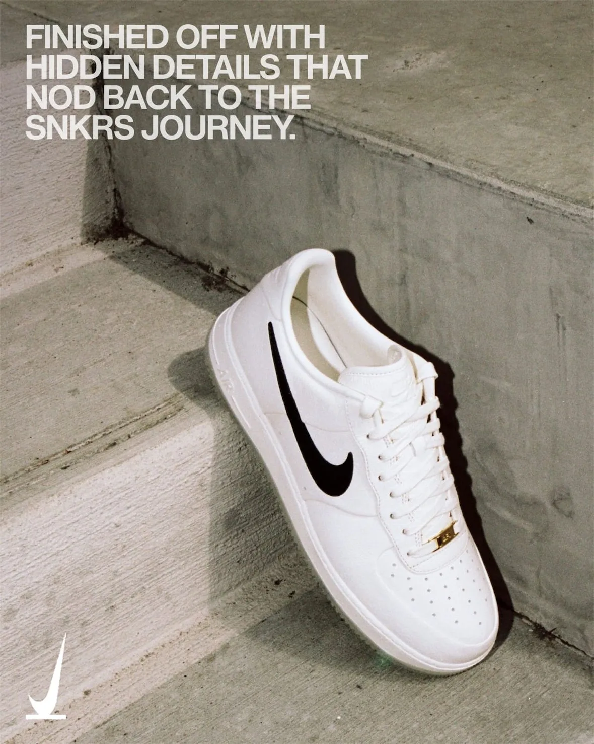 Lateral view propped on concrete steps, cream upper with black swoosh, gold lace tag and text overlay, SNKRS Friends & Family