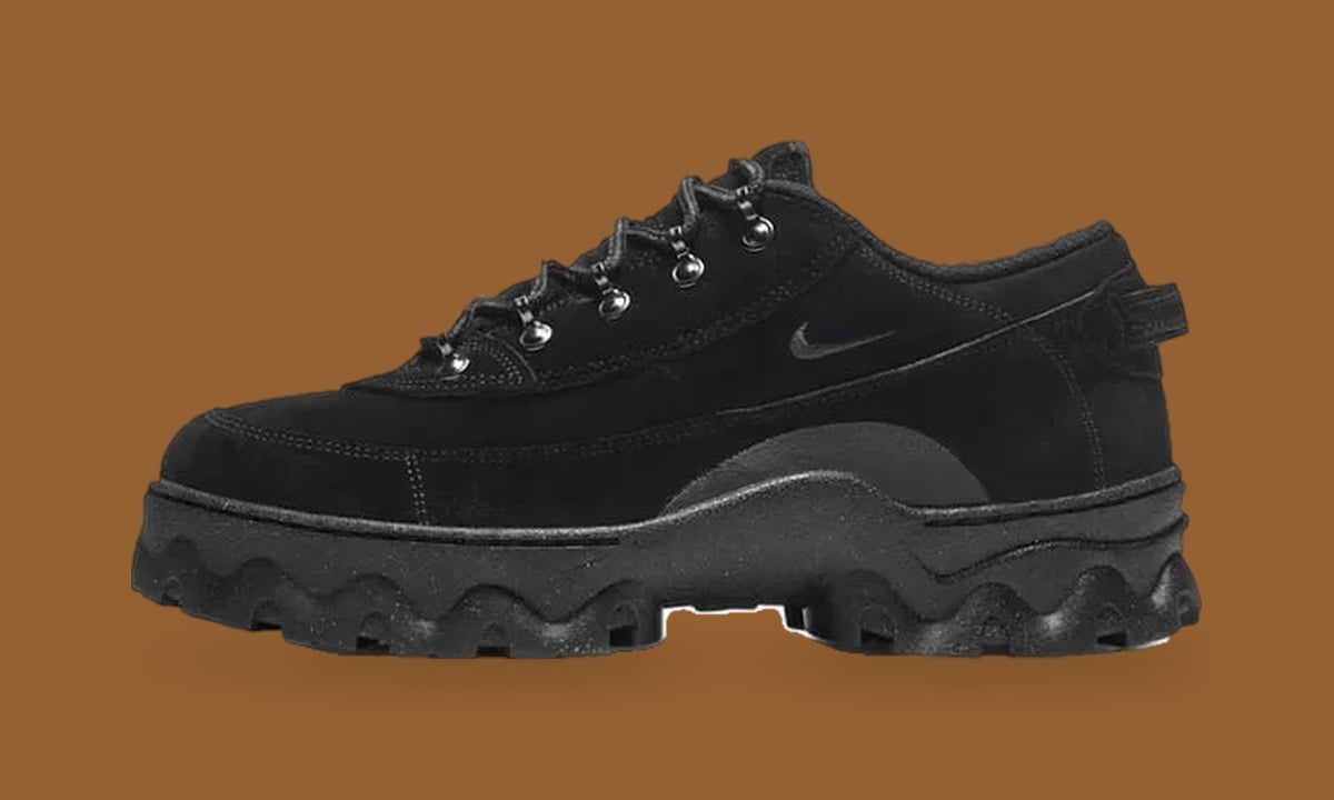 Lateral view of all-black suede low boot with tonal swoosh and silver eyelets, Black