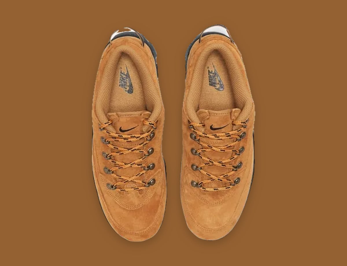 Top-down view of tan suede pair with orange and black laces and Nike insoles, Black