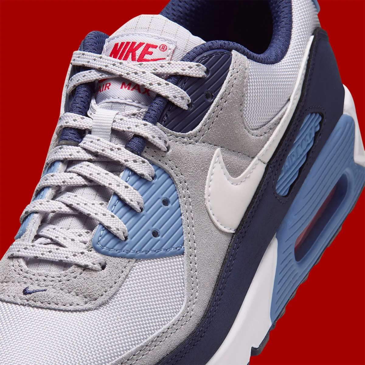 Detail of toe and laces, speckled grey laces, red Nike tongue label, white swoosh, Geyser Grey