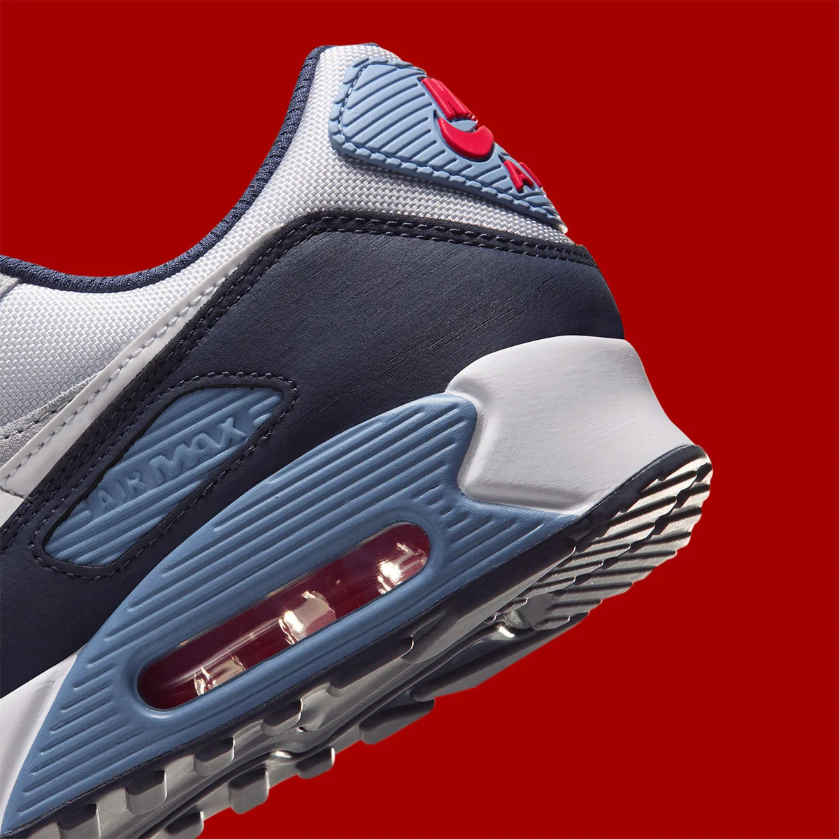 Detail of heel, light blue Air Max window with red cushioning, navy overlay, Geyser Grey