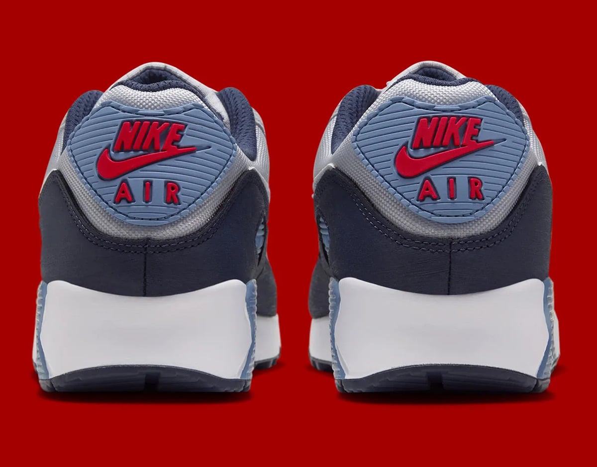 Pair, heel view, red Nike Air logo on light blue heel tab, white midsole, Geyser Grey